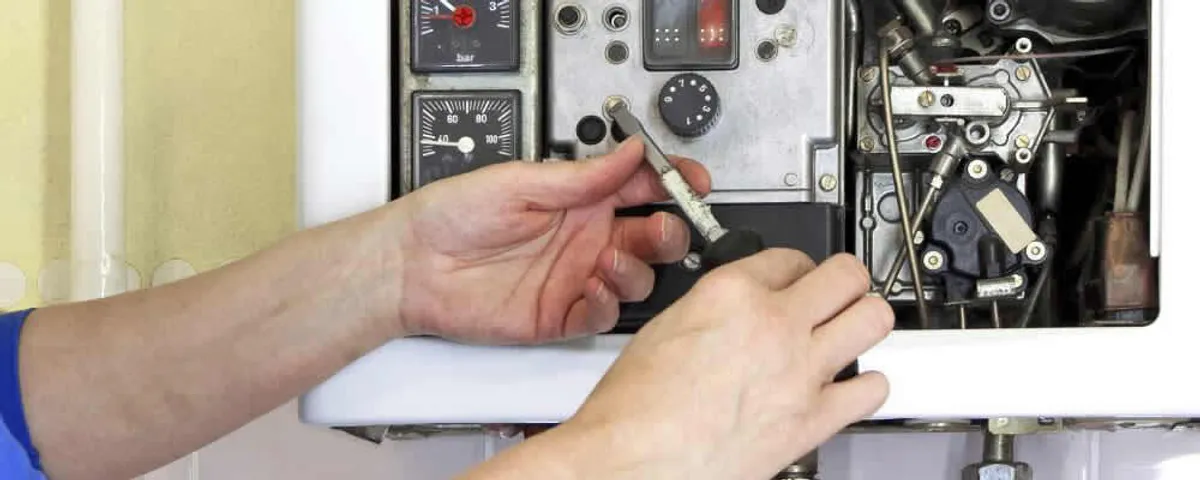 Heating repair technician adjusting boiler controls and components in Boise, ID