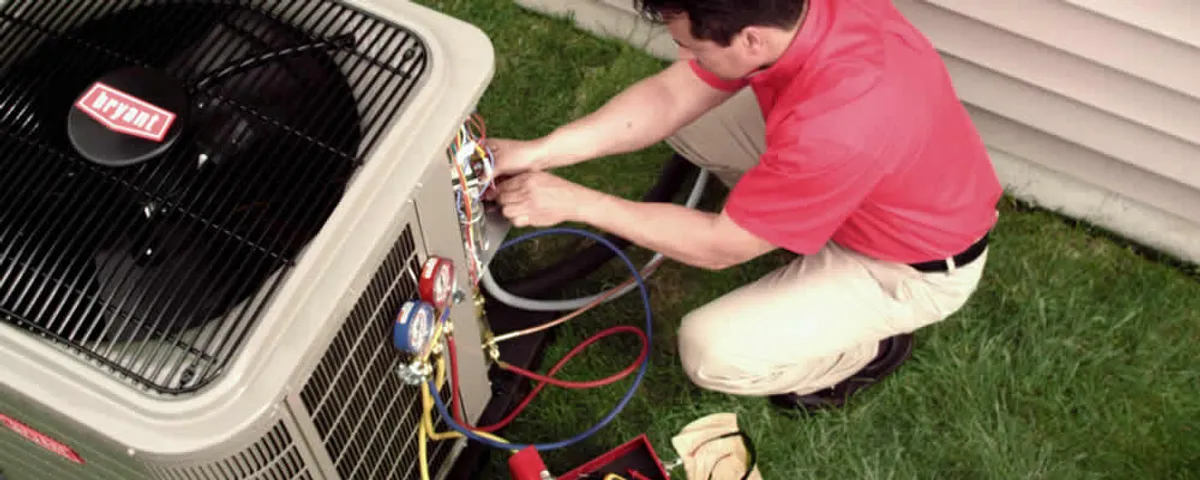 HVAC technician servicing an outdoor air conditioner unit in Boise, ID