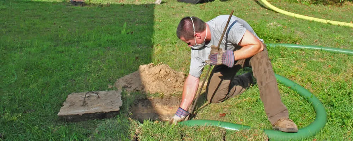 Septic pumping technician servicing a residential septic tank in Boise, ID